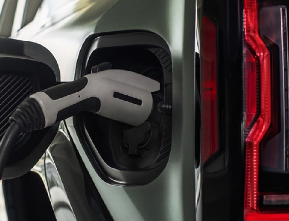 Close up of charging port with charger plugged in on a GMC Hummer EV SUV - White's Frontier Motors in Gillette WY