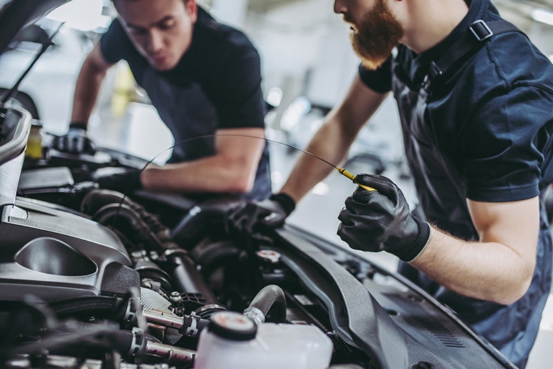 Two machanic servicing a car